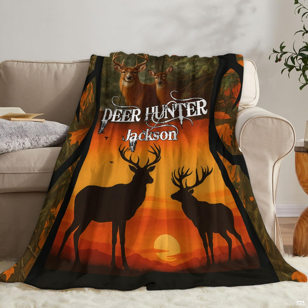 Autumn wildlife blanket draped neatly over a living room couch beside an accent pillow.