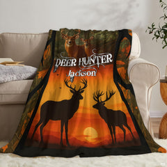 Autumn wildlife blanket draped neatly over a living room couch beside an accent pillow.