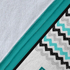 Lifestyle interior presentation of teal wrestling collage blanket in a modern room.