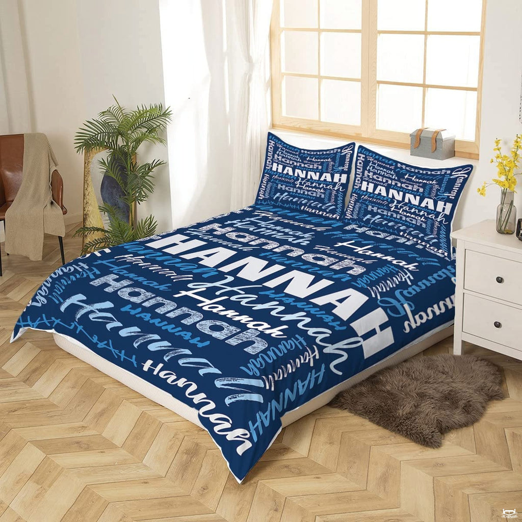 Close-up perspective of blue typography bedding showing textured chalk lettering and calligraphy brushstrokes