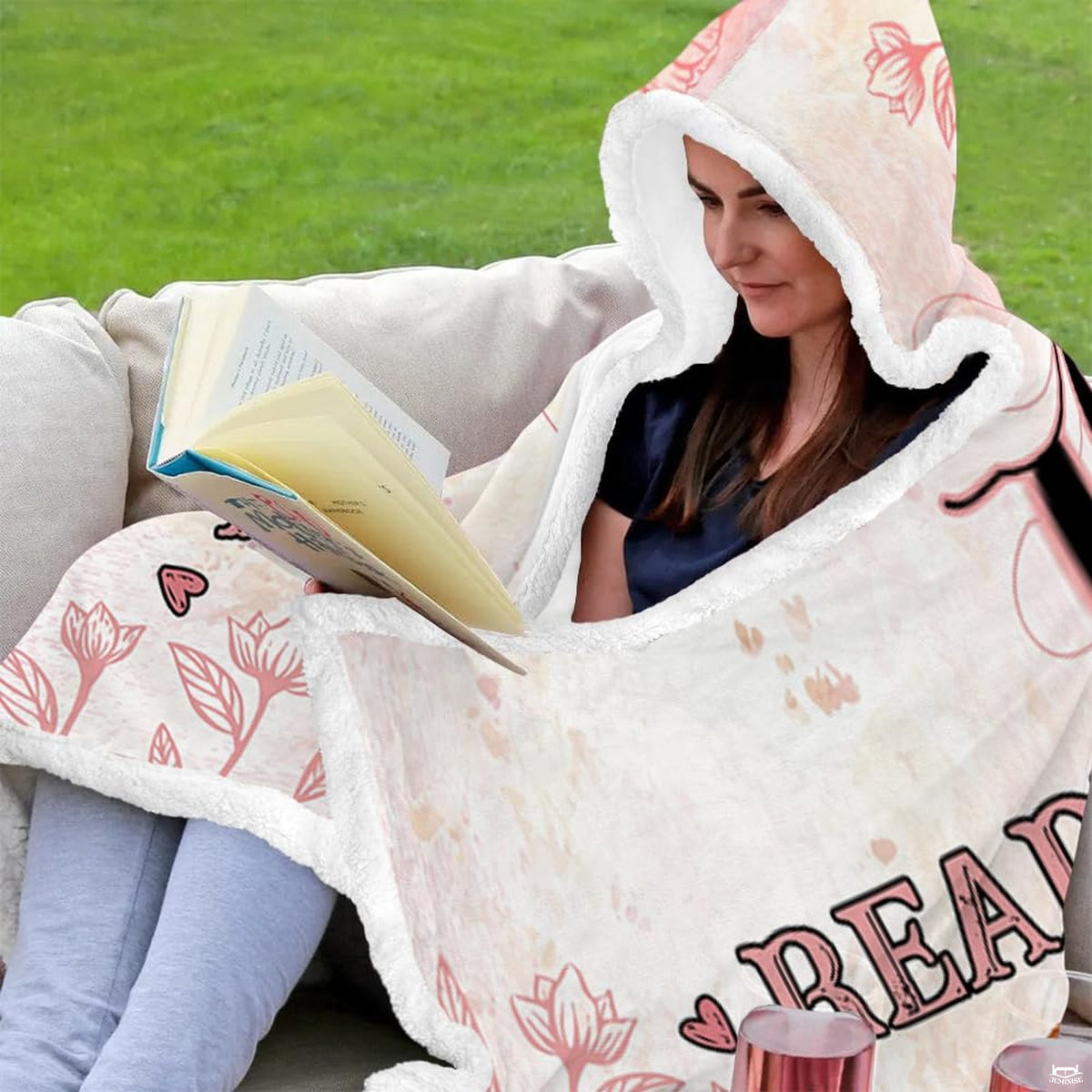 Model wearing pink botanical novel throw blanket showing front and back views with floral line drawings
