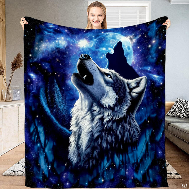 Howling wolves cosmic throw blanket featuring wolves under a luminous full moon and starry night sky.