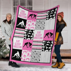 Detail view of neat hemmed edge and high-contrast printing on pink wrestling blanket.