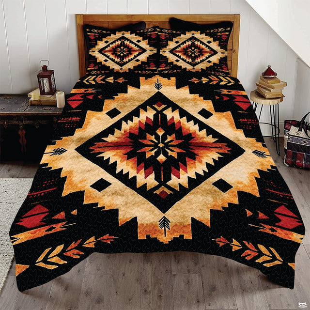 Golden ochre and onyx black Aztec tribal bedding set displayed neatly on a bed in a rustic bedroom