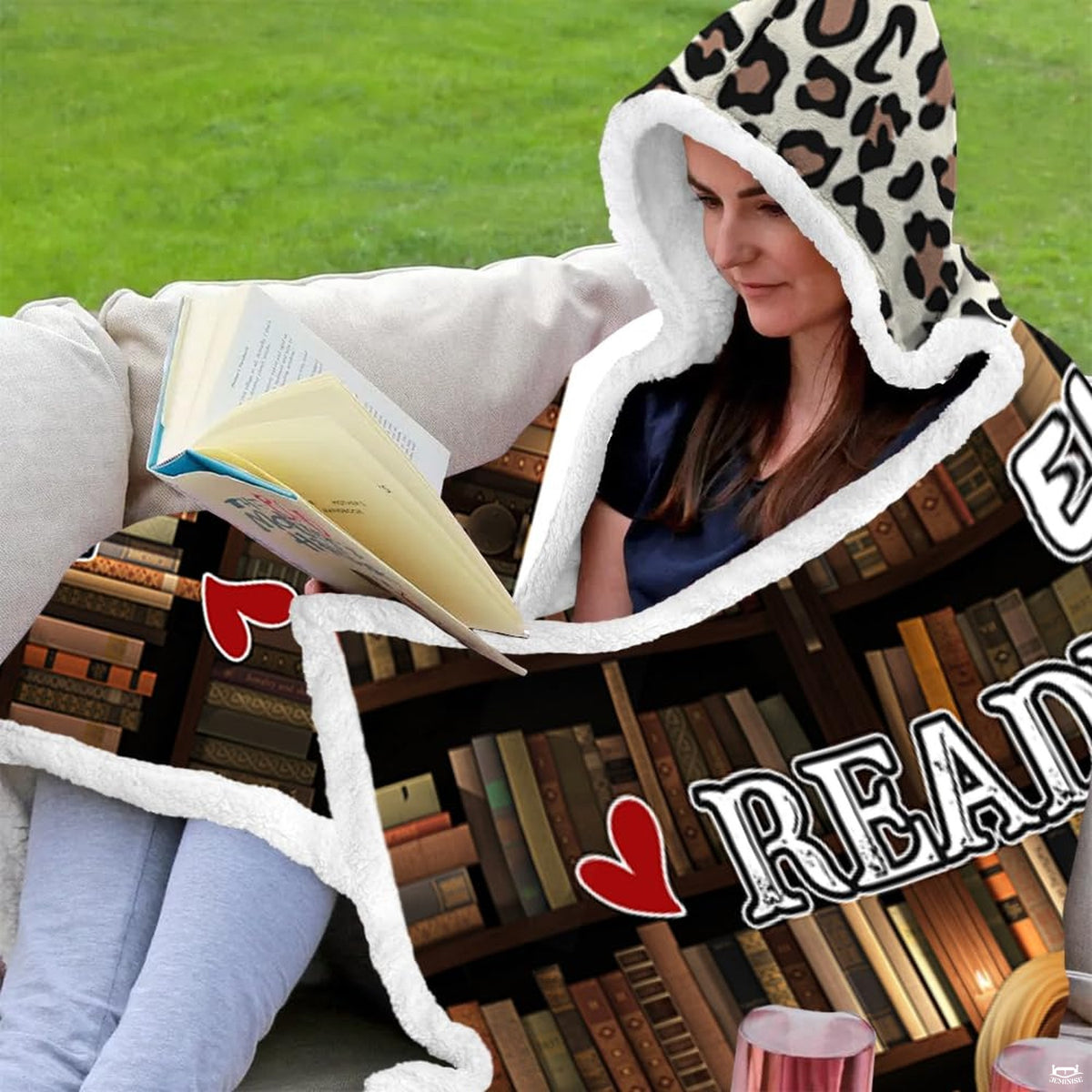Bedroom styling with library book bedding showing leopard print trim accents and bookshelf illustrations.