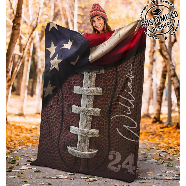Close view of weathered football laces and draped flag on blanket