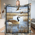 Canada goose floating on marsh water with flying geese and autumn cattails, view 1.