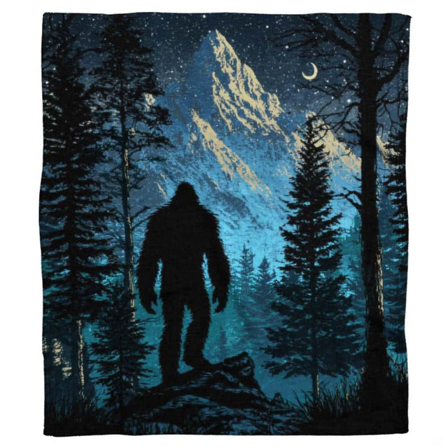 Bigfoot mountain throw blanket draped over a living room sofa in a modern home