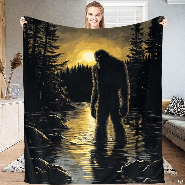 Bigfoot silhouette standing in calm lake waters under a radiant golden pine forest sunset.
