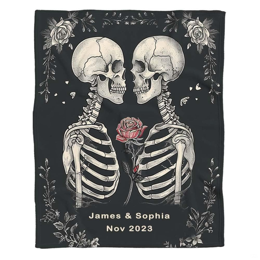 Flat front display of gothic skeleton lovers holding red rose on charcoal.