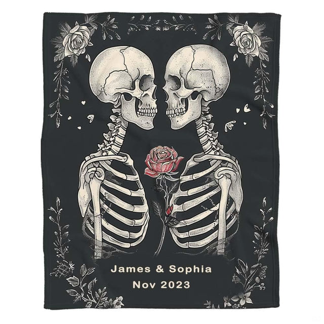 Flat front display of gothic skeleton lovers holding red rose on charcoal.