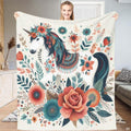 Bohemian floral unicorn folk throw blanket showing white unicorn in coral flower garden