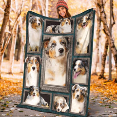 Model displaying the rectangular Australian Shepherd portrait blanket outdoors in an autumn park.