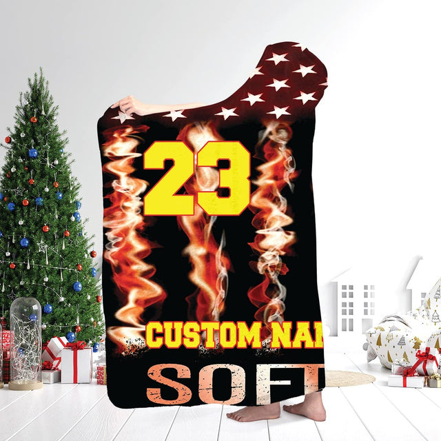Close-up visual print of optic yellow softball graphic against fiery red and orange smoke streaks.