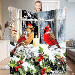 Winter cardinals throw blanket featuring birds on snowy window ledge with glowing candle.
