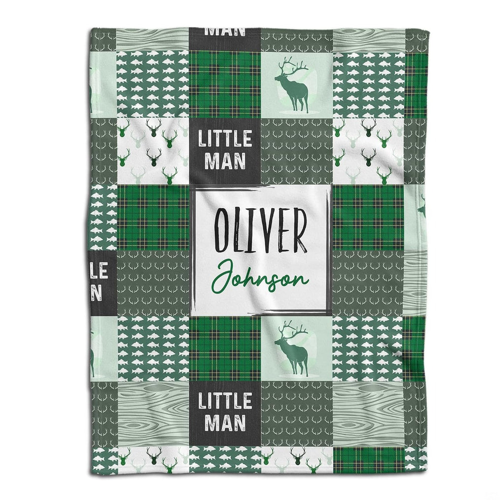 Woodland deer baby blanket displayed flat showing green rustic patchwork squares and stag silhouettes
