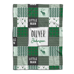 Woodland deer baby blanket displayed flat showing green rustic patchwork squares and stag silhouettes