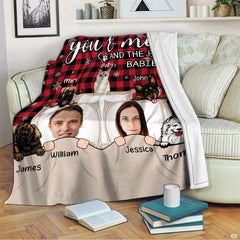 Illustrated couple and cartoon pets on red and black buffalo plaid background, view 3.