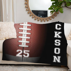 Football sports throw blanket draped across cream sofa beneath decorative mirror