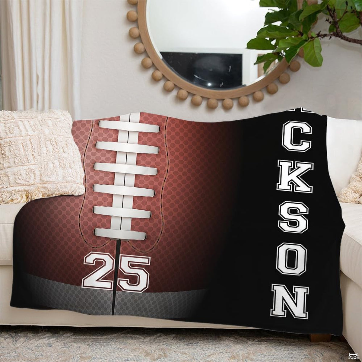 Football sports throw blanket draped across cream sofa beneath decorative mirror
