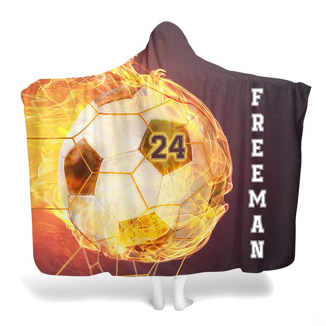 Flaming soccer ball blanket featuring a blazing fire soccer ball in goal net with athletic vertical lettering.