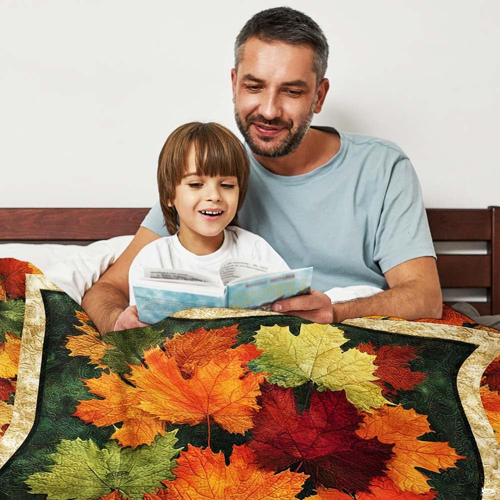 Close-up perspective of colorful maple leaves and border on throw blanket