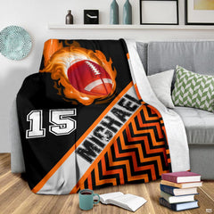 Blazing football graphic blanket styled across bedroom bed