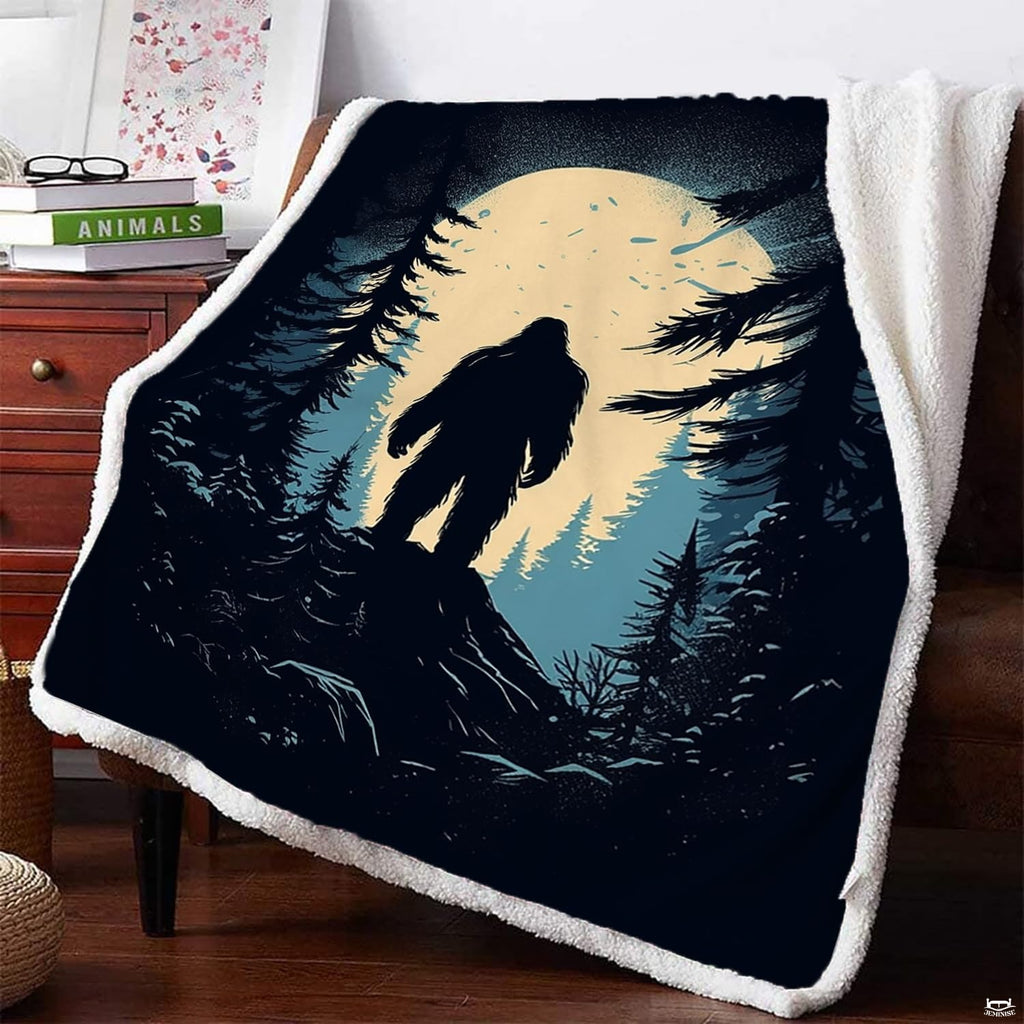 Bigfoot rocky ridge blanket draped on armchair featuring Sasquatch under full moon.