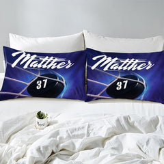 Side angle view of athletic winter sports bedding showing deep midnight navy and ice blue tones on mattress