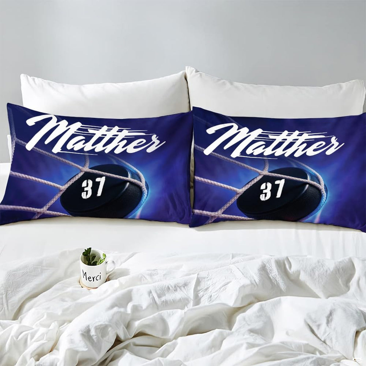 Side angle view of athletic winter sports bedding showing deep midnight navy and ice blue tones on mattress