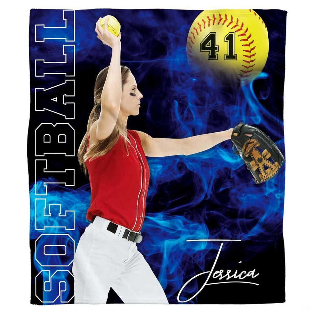 Frontal view of fastpitch pitcher executing pitch amidst electric blue smoke and optic yellow game ball.