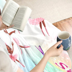 Nursery lifestyle display highlighting the cheerful dance-themed decorative blanket.