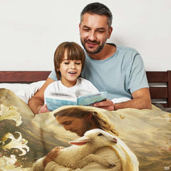 Father and child reading together while nestled under the Good Shepherd Jesus blanket.