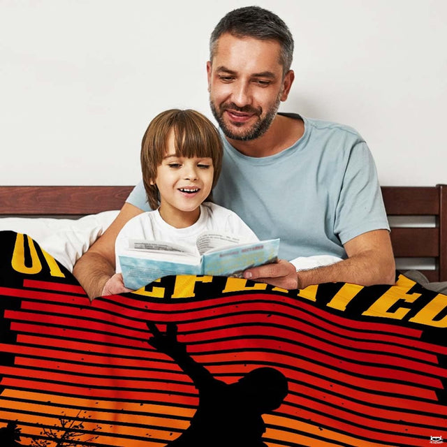 Close view of Sasquatch silhouette and pine tree accents on vibrant striped retro bedding artwork.