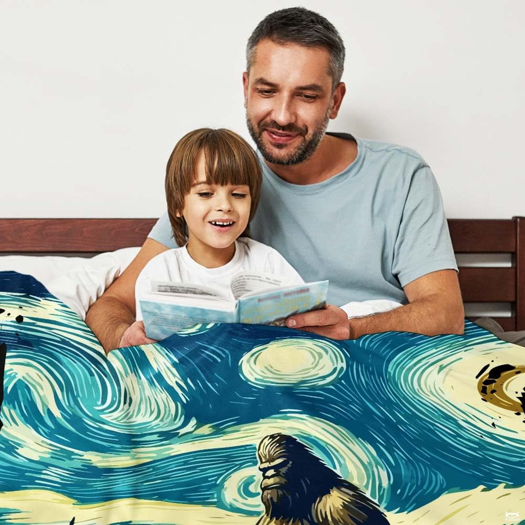 Father and child reading in bed covered by artistic starry night Bigfoot blanket
