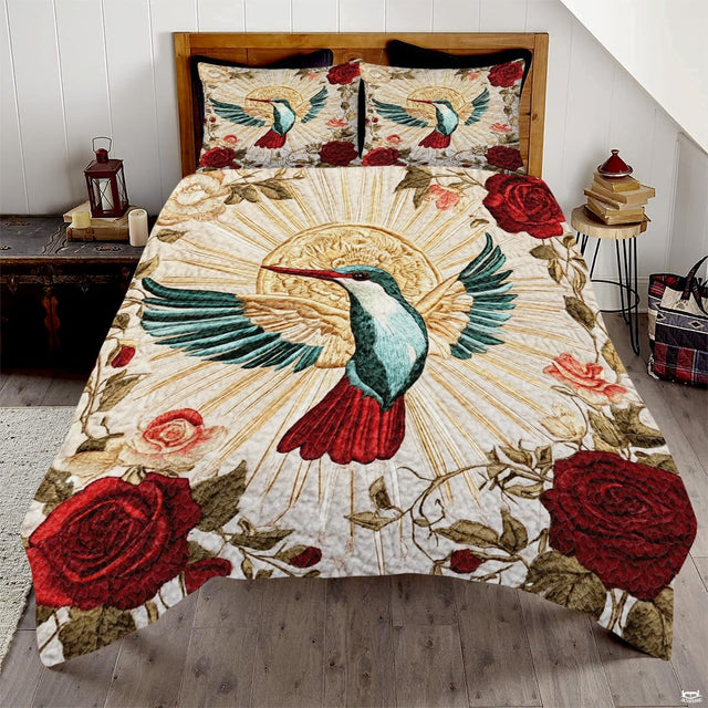 Teal hummingbird with red tail, gold sunburst, and red rose bedding art