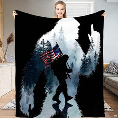 Patriotic Bigfoot throw blanket displaying Sasquatch silhouette with American flag and misty pine forest