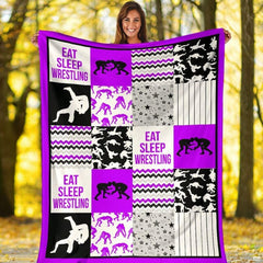 Purple wrestling sports throw blanket styled across a bed in a modern bedroom setting.