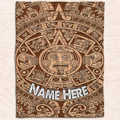 Burnt wood Aztec sun calendar graphic textile displayed flat on light wood planks.
