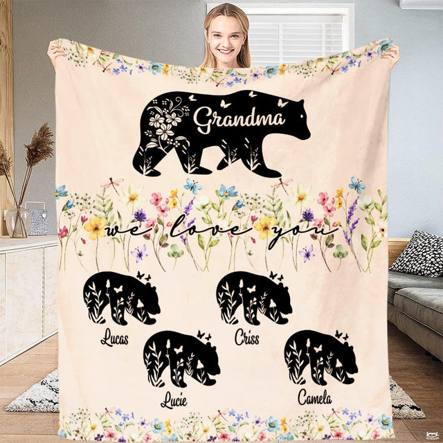 Floral meadow border illustration featuring a mother bear silhouette and cubs on a cream backdrop.