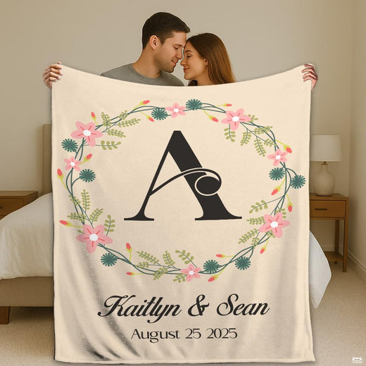 Wedding floral monogram initial wreath throw blanket featuring pink blossom ring and couple lettering on cream