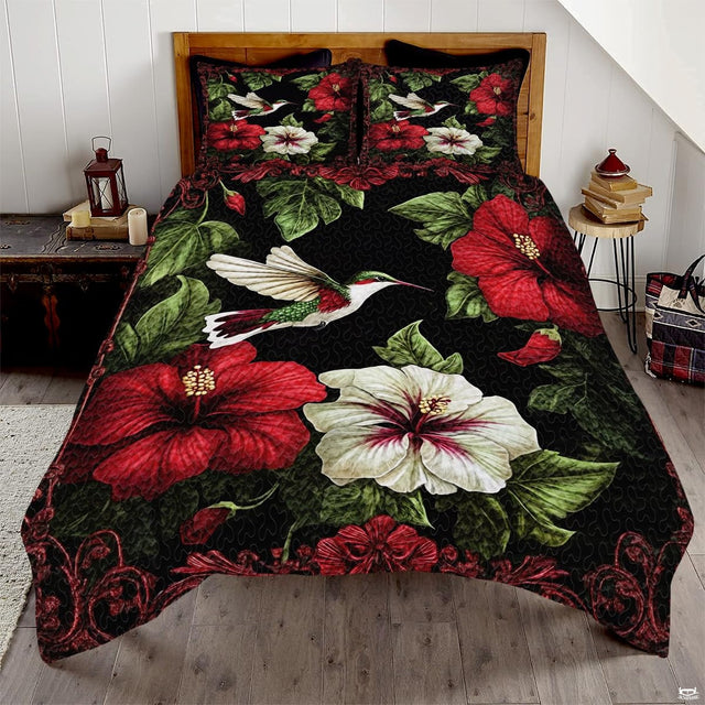 Hummingbird bedding art with red and white hibiscus flowers on black