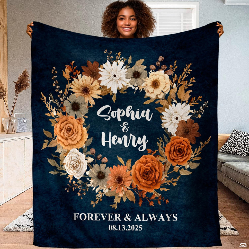 Autumn floral wreath navy throw blanket held open showing rich botanical circular garland artwork