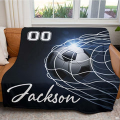 Close view of soccer ball bulging net cords with light flare graphic
