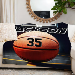 Side angle of basketball themed bedding highlighting vivid orange highlights and stadium glow.