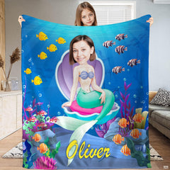 Under the sea bedding set artwork displaying swimming cartoon fish, coral reefs, and bubbles on ocean blue.