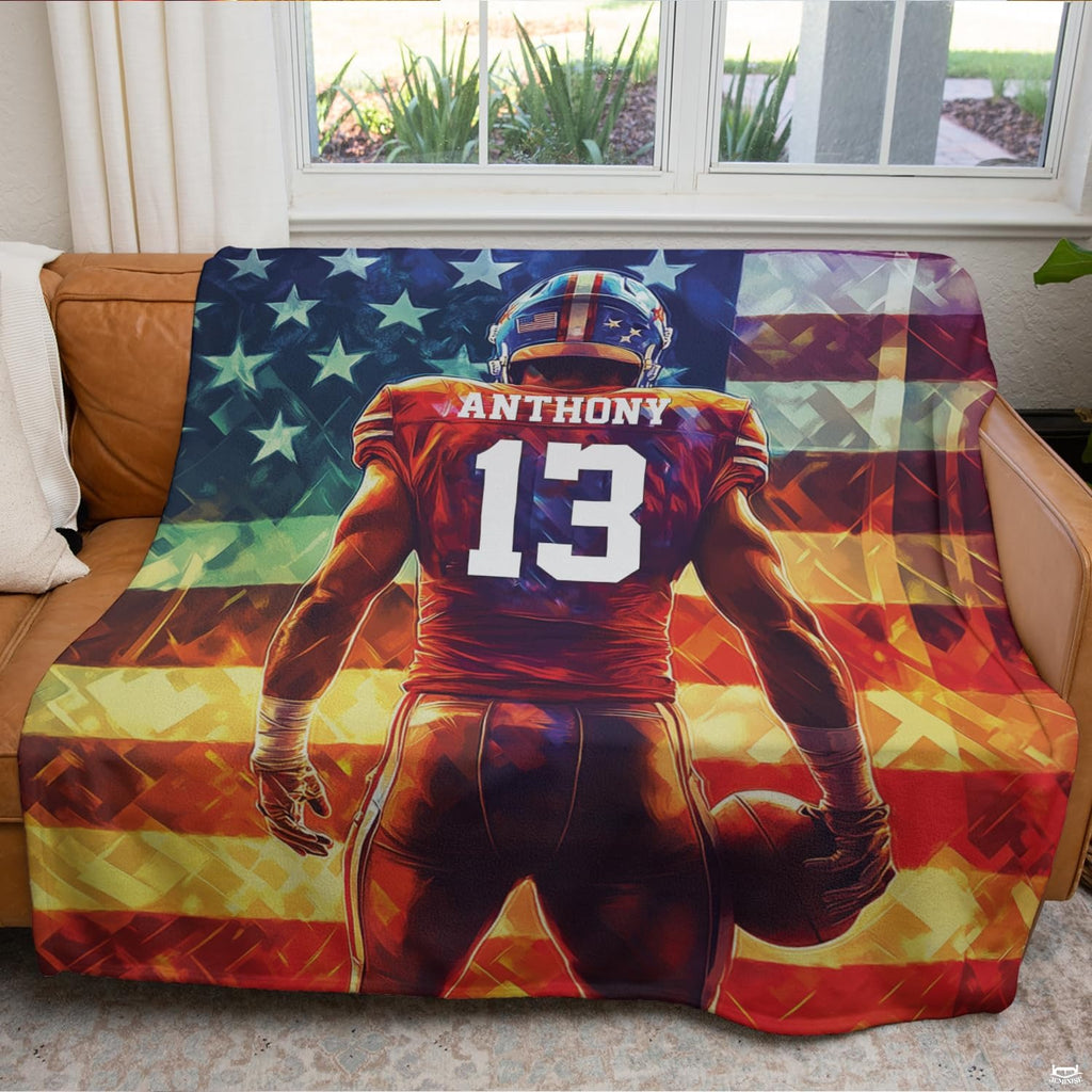 Patriotic football blanket displayed across brown leather couch in bright living room