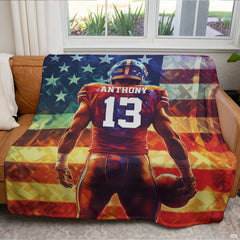Patriotic football blanket displayed across brown leather couch in bright living room