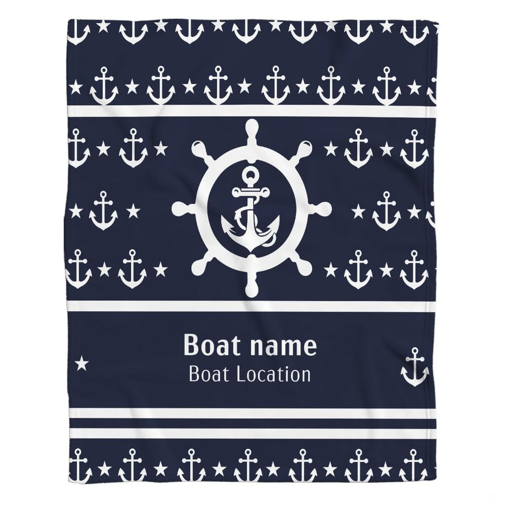 Nautical helm and anchor graphic blanket draped across bedroom bed