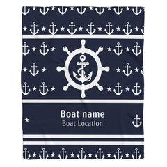 Nautical helm and anchor graphic blanket draped across bedroom bed